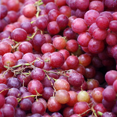 Fresh red grapes on display at a farmers market