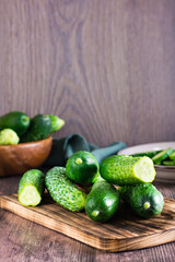 Fresh cucumbers on a cutting board on the table. Dietary organic food. Vertical view