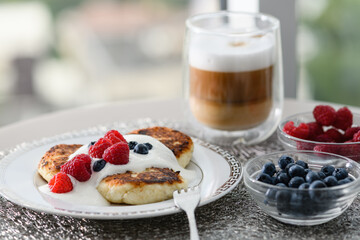 Cottage cheese pancakes with blueberries and raspberries.