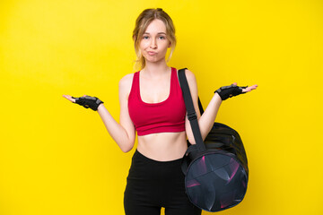 Young sport caucasian woman with sport bag isolated background having doubts while raising hands