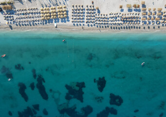 Drone photo of the summer beach resort with umbrellas at the Ionian Sea coast in Albania, Borsch