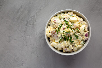 Homemade Healthy Potato Salad with Eggs in a Bowl on a gray background, top view. Flat lay,...