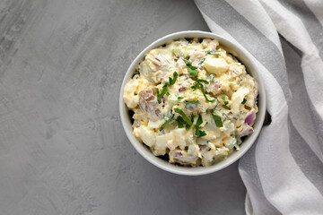 Homemade Healthy Potato Salad with Eggs in a Bowl on a gray background, top view. Flat lay, overhead, from above. Copy space.