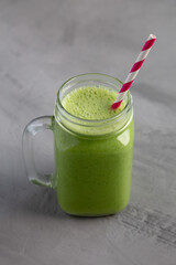 Homemade Greek Yogurt Green Smoothie with Spinach and Banana in a Jar, side view.
