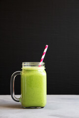 Homemade Greek Yogurt Green Smoothie with Spinach and Banana in a Jar, side view. Copy space.