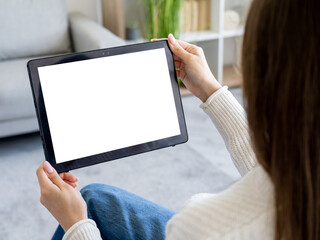 Virtual life. Online technology. Digital mockup. Unrecognizable woman holding tablet computer with blank screen in hands light room interior.