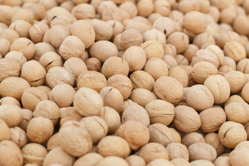 Walnuts in shell.Background from fresh walnuts. Selective focus.