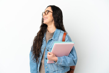 Fototapeta premium Young student woman isolated on white background laughing in lateral position