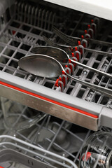 Close-up of clean cutlery in the dishwasher.