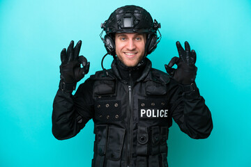 SWAT caucasian man isolated on blue background showing an ok sign with fingers