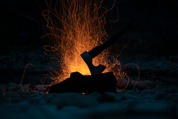 Viking ax. An ax driven into a piece of wood. Ax in the water. An ax by the fire