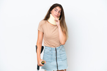 Young caucasian woman wearing neck brace and crutch isolated on white background and looking up