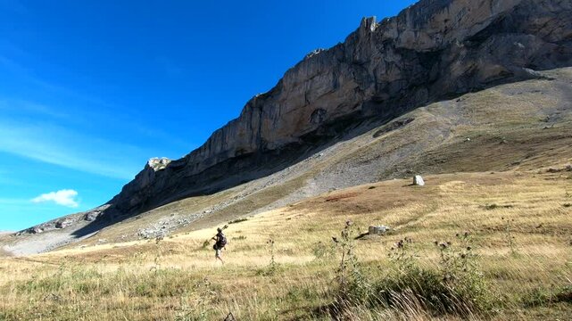 young caucasian woman hike impressive rock mountain landscape.