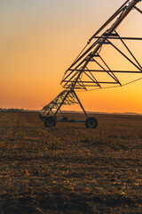 sunset in the countryside, irrigation system.