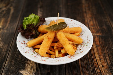 Potato croquettes with french fries on the white plate. Delicious unhealthy appetizer. Beer platter...