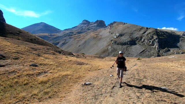 young caucasian woman hike moutain dry grass.
