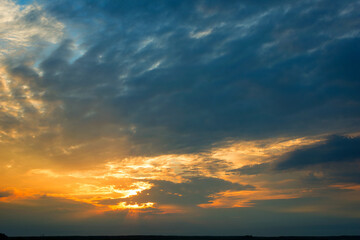Naklejka na ściany i meble Bright dramatic sky with clouds at sunset