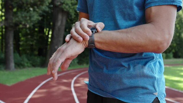Man use fitness watch before cardio exercises, Checking results on smart watch after training, Healthy lifestyle concept