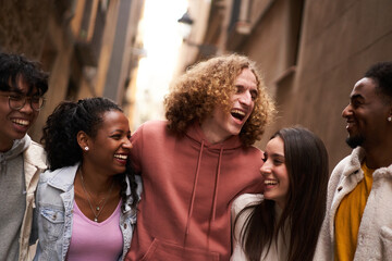 Fototapeta premium Group Of Happy Friends Having Fun Together Outdoors. Mixed race people laughing making community.