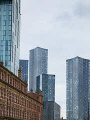 Fototapeta na wymiar Modern skyscrapers= towers set against classical victorian buildings around Deansgate in Manchester, UK