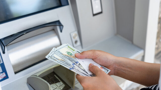 Atm machine money cash. Woman withdraw money bill. Holding american hundred dollar cash. Bank credit card and dollar bill.