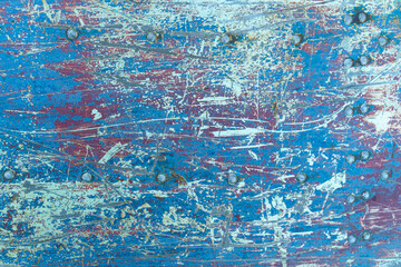 Texture of rusty metal with rivets, blue and red paints.