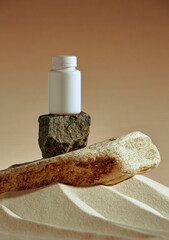 Mock up plastic jar on stone podium in desert sand. Template package of vitamins, dietary...