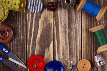 Sewing tools and supplies on wooden background table. Tailor handmade clothes concept