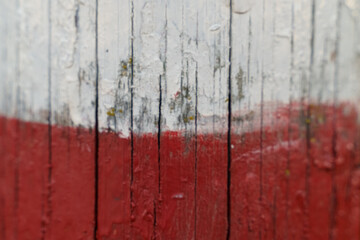 Poland flag on an old painted wooden surface.