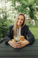 Portrait of a stunning young woman drinking a mojito cocktail in a cafe.