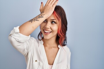 Young caucasian woman wearing casual white shirt over isolated background surprised with hand on...