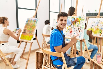 Group of people smiling happy drawing at art studio.