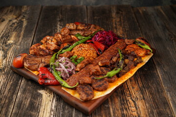 Turkish traditional mixed kebab on wooden plate. Turkish and Arabic Traditional Mix Kebab Plate...