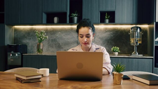Young caucasian business woman using typing on laptop notebook keyboard sit at homeoffice.Ethnic businesswoman looking at laptop computer,online conference distance office chat,work from home remotely