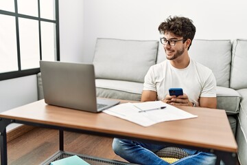 Young hispanic man smiling confident working at home