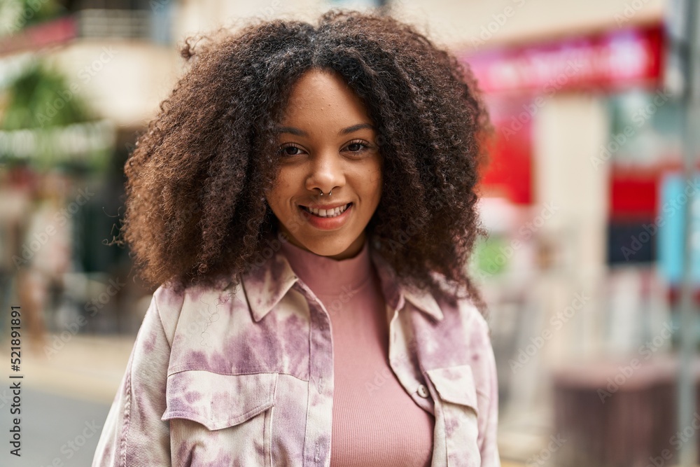 Poster Young african american woman smiling confident standing at street