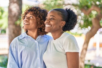 African american women mother and daughter standing together at park