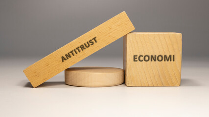 Antitrust written on wooden surface. economy and business.