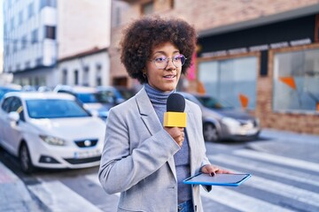 African american woman reporter working using microphone and touchpad at street