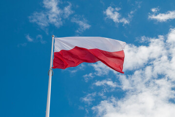 Fototapeta na wymiar flag political poland against the background of the sky and clouds