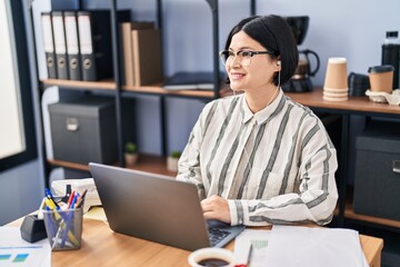 Young chinese woman business worker using laptop working at office