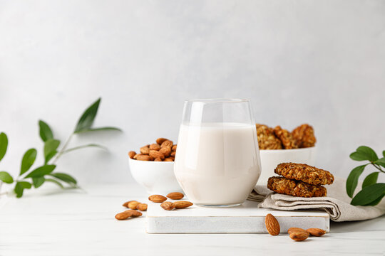 Almond milk in a glass and almond nuts
