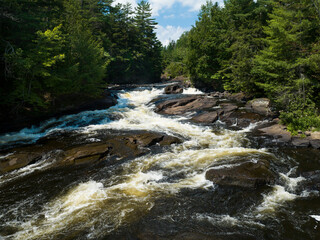 Beautiful waterfall flowing during summer in a northern forest in Canada
