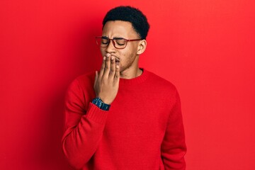 Young african american man wearing casual clothes and glasses bored yawning tired covering mouth with hand. restless and sleepiness.