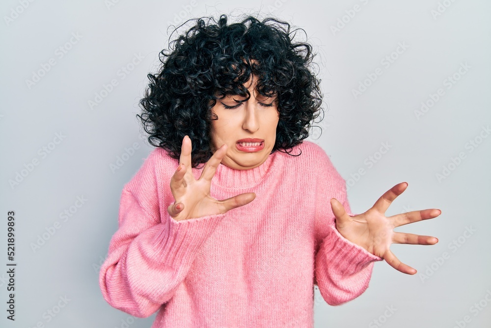 Sticker Young middle east woman wearing casual clothes disgusted expression, displeased and fearful doing disgust face because aversion reaction.