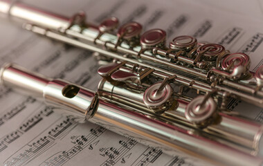 Close up of the flute musical instrument on the music sheet
