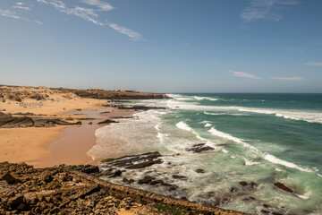 Beach with sand and rocks and plenty of waves on the Atlantic coast of Portugal