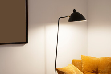 Reading corner with camel velvet cushions and black design lamp