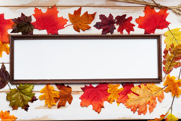 Autumn composition. Thanksgiving holiday concept. Photo frame and autumn leaves.