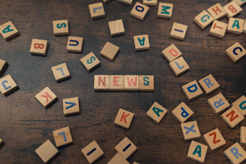 NEWS. Information and proper sources concept. Symbolic depiction of the news with the use of wooden square colourful letters. High quality photo